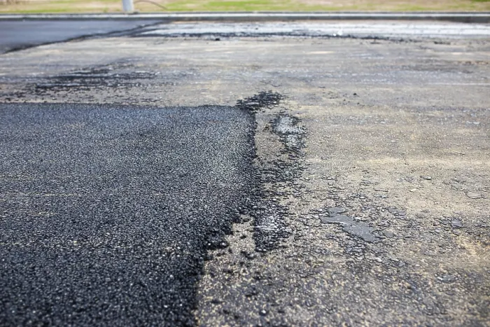 Framed Print : Road with contrasting areas of new asphalt and old surface in a wide view