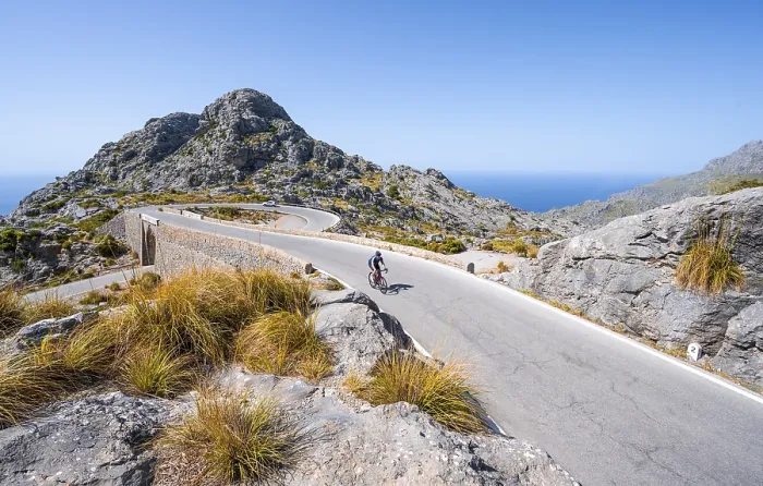 Framed Print : Road cyclists at the mountain pass with serpentines to Sa Colobra