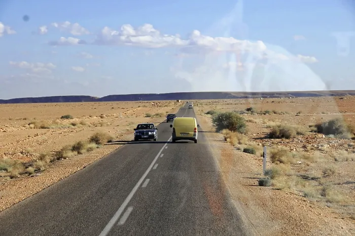 Framed Print : On the road to Erfound, Yellow car and another vehicle on an endless road in the desert