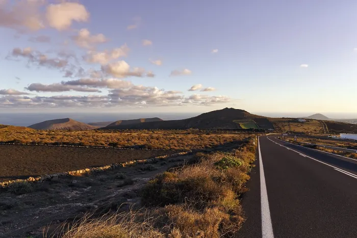 Framed Print : Road leads through hilly volcanic landscape Framed Print : Road leads through hilly volcanic landscape