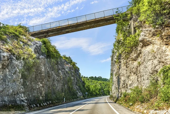 Framed Print : Road through mountains under connecting bridge in Montenegro