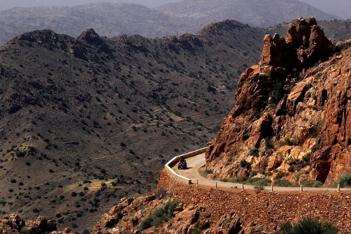 Framed Print : Road snakes through a rocky, dry mountain landscape