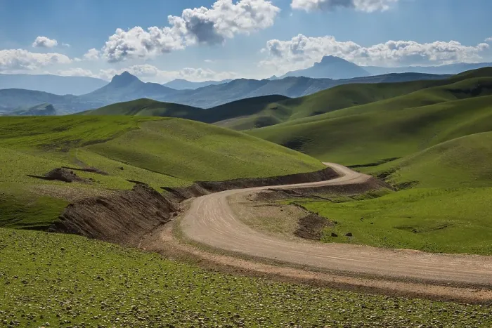 Framed Print : Road sneaking through the green hilly landscape