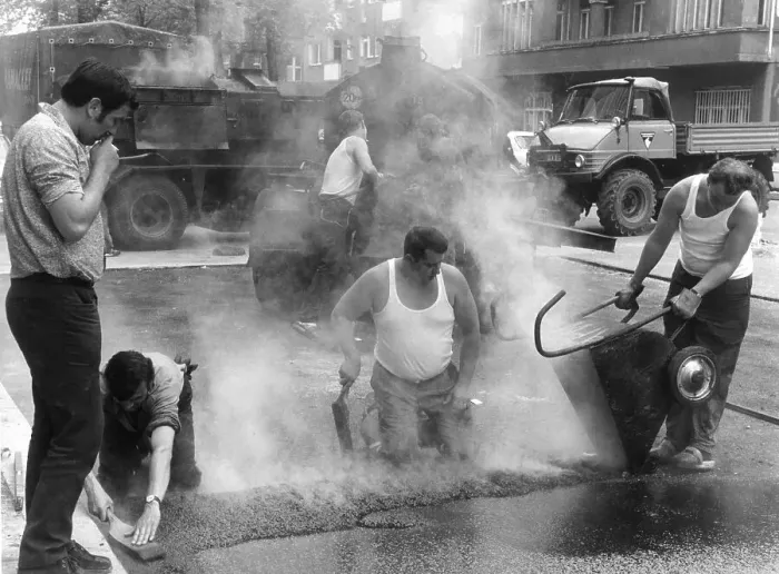 Framed Print : Road workers take tar to the streets