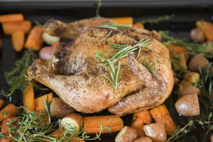 Framed Print : A roast chicken on a baking tray with rosemary