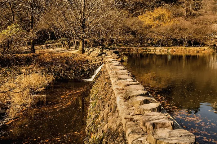 Framed Print : Rock footbridge across small lake on autumn morning Framed Print : Rock footbridge across small lake on autumn morning