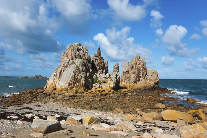 Framed Print : Rock formations on a sunny coast under a blue sky with clouds Framed Print : Rock formations on a sunny coast under a blue sky with clouds
