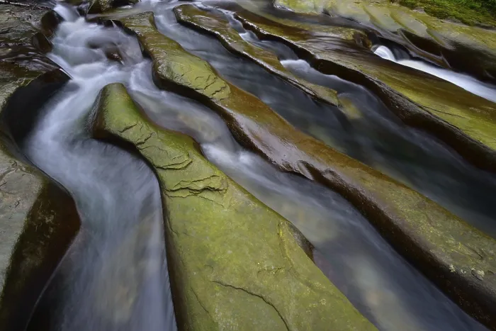 Framed Print : Rock gullies formed by water in the riverbed