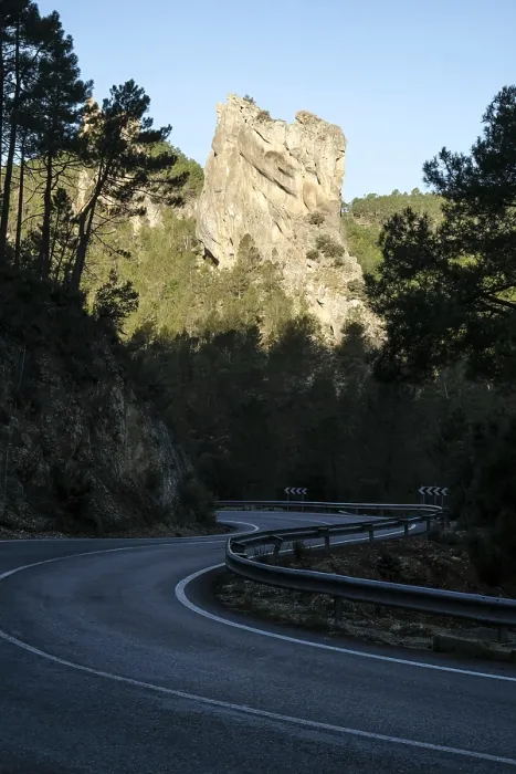 Framed Print : Rock in morning light, country road in the shade
