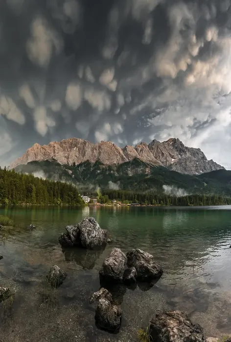 Framed Print : Rocks on the shore, Eibsee lake in front of Zugspitze massif with Zugspitze