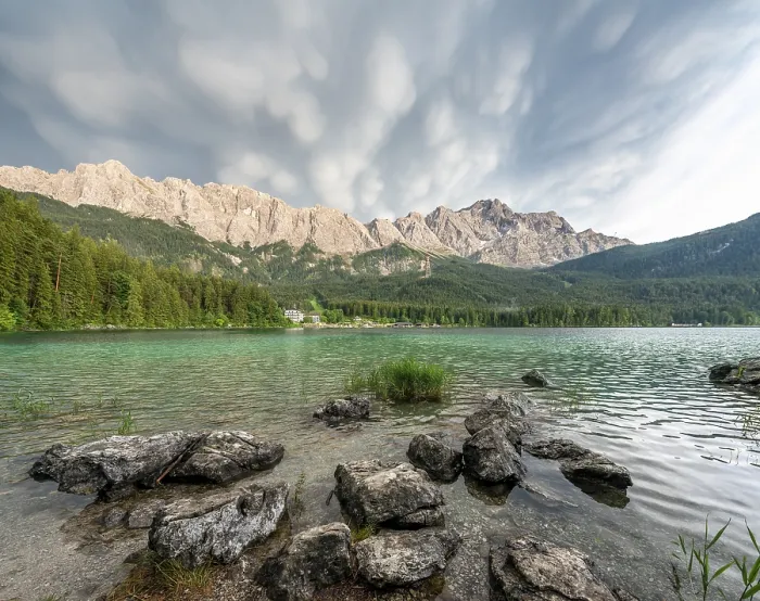 Framed Print : Rocks on the shore, Lake Eibsee lake in front of Zugspitze massif with Zugspitze Framed Print : Rocks on the shore, Lake Eibsee lake in front of Zugspitze massif with Zugspitze