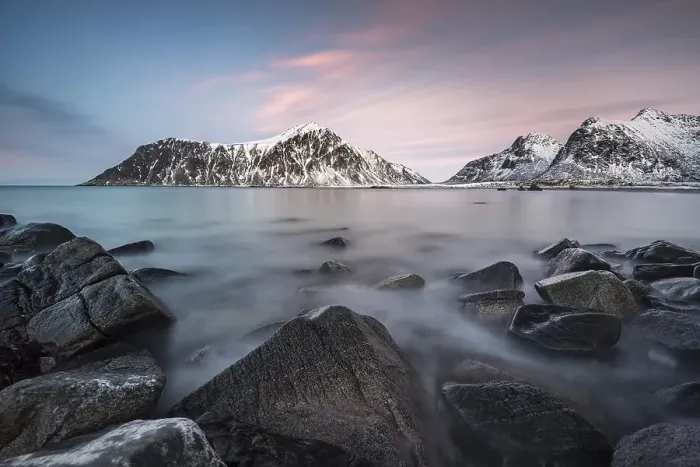 Framed Print : Rocky coast, mountains in the background