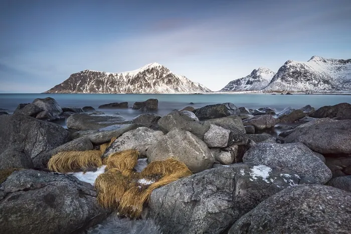 Framed Print : Rocky coast, mountains in the background