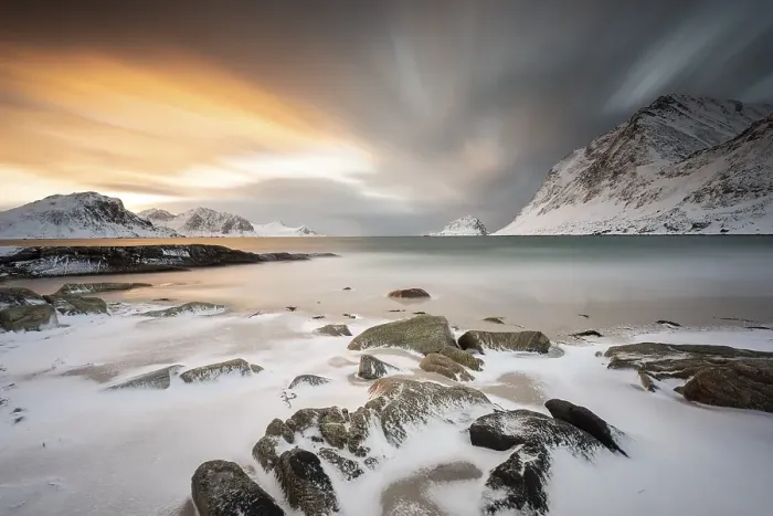 Framed Print : Rocky coast with snow at sunset
