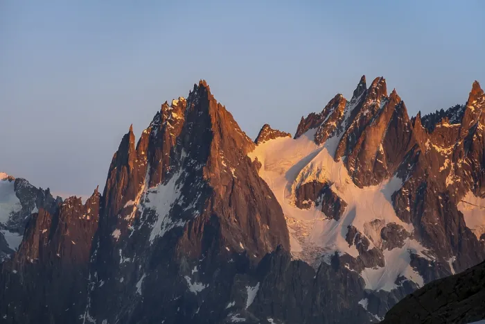 Framed Print : Rocky pointed mountain peaks at sunset