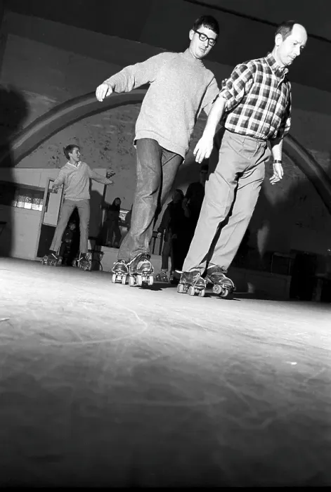 Framed Print : Roller skate fun in the 1960s. Interior of a roller disco with people roller skating