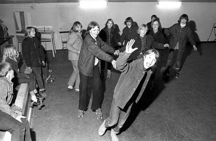 Framed Print : Roller skate fun in the 1960s. Interior of a roller disco with people roller skating