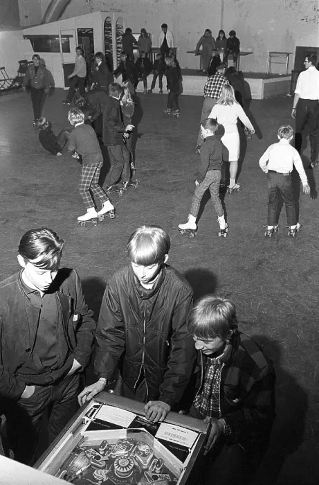 Framed Print : Roller skate fun in the 1960s. Interior of a roller disco with people roller skating