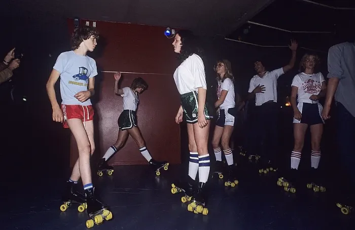 Framed Print : Roller skate fun in the 1970s. Interior of a roller disco with people roller skating
