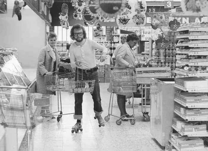 Framed Print : Roller skates 1972. A man on roller skates is seen in a grocery store, shopping along with two ladies. Sweden 1972