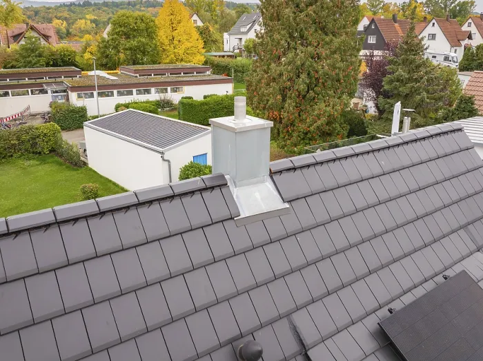 Framed Print : Roof with anthracite-colored tiles and modern chimney