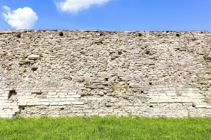 Framed Print : Rough stone wall of the ancient medieval fortress Izborsk in summer