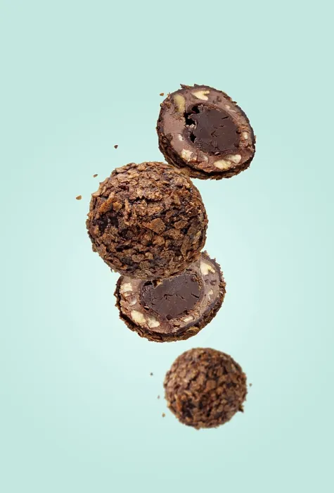 Framed Print : Round chocolates flying on a blue background