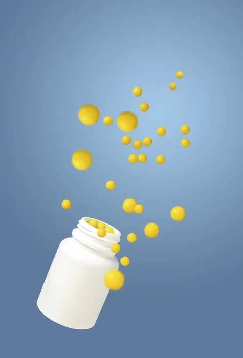 Framed Print : Round yellow vitamins and a white bottle are flying on a blue background