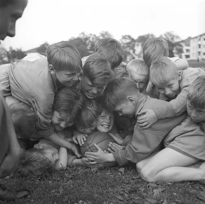 Framed Print : Rugby 1940. A group of young rugby players all on top of one smiling boy who holds on to the rugby ball