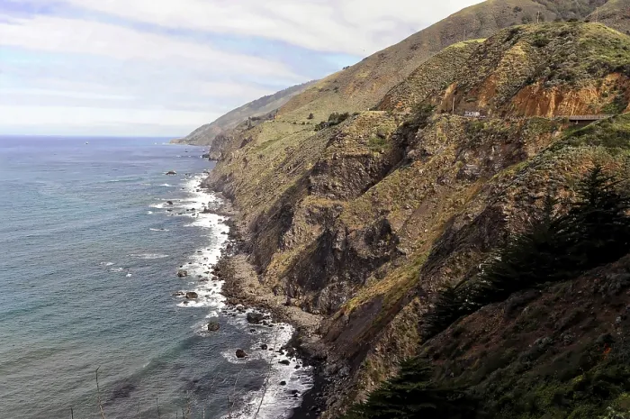 Framed Print : Rugged coastline with high cliffs and distant mountains Framed Print : Rugged coastline with high cliffs and distant mountains