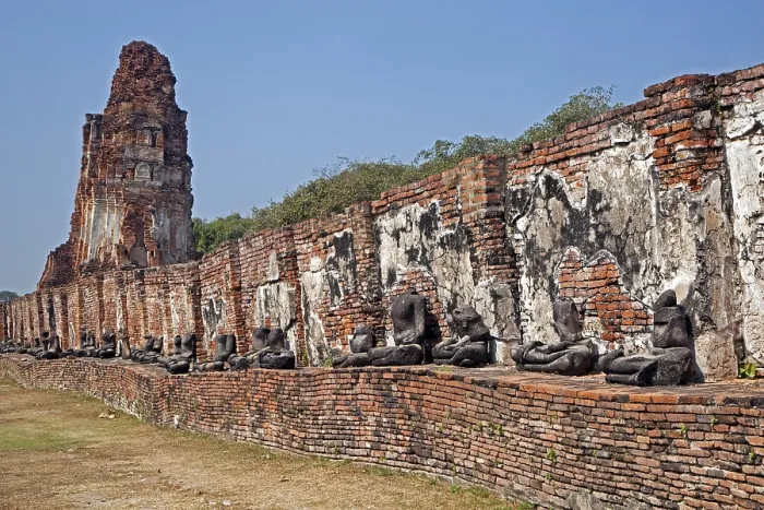Framed Print : Ruin of a Buddhist stupa with a row of broken Buddha statues at Wat Mahathat in Ayutthaya Historical Park
