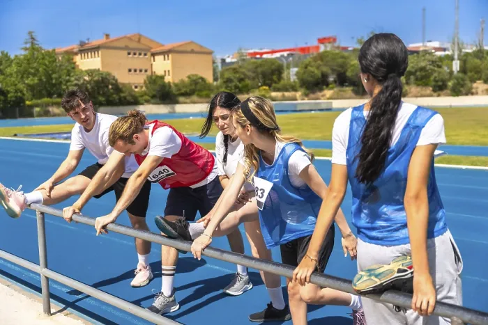 Framed Print : Runners stretching their legs on a vibrant blue track