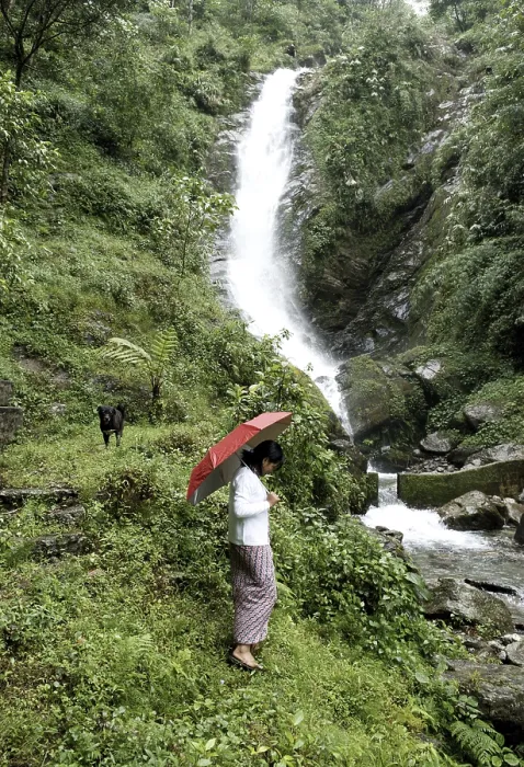 Framed Print : Rural woman at waterfall, Pastanga, Sikkim, India