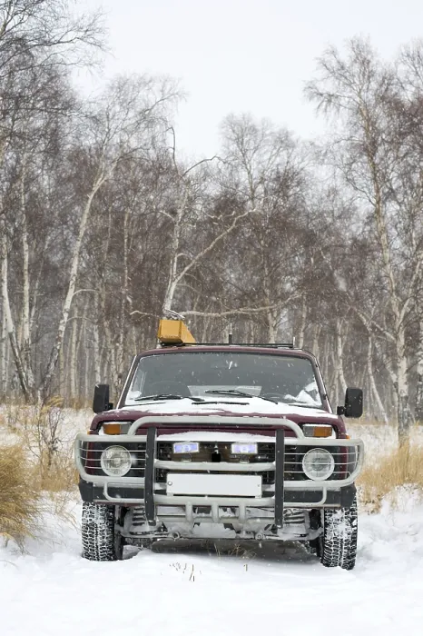 Framed Print : Russian off-road four-wheel drive vehicle in winter birch forest while snowing Framed Print : Russian off-road four-wheel drive vehicle in winter birch forest while snowing