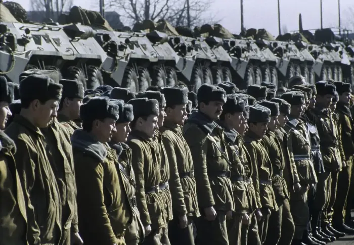 Framed Print : Russian soldiers standing in front a train transporting armoured vehicles during the withdrawal of Soviet troops