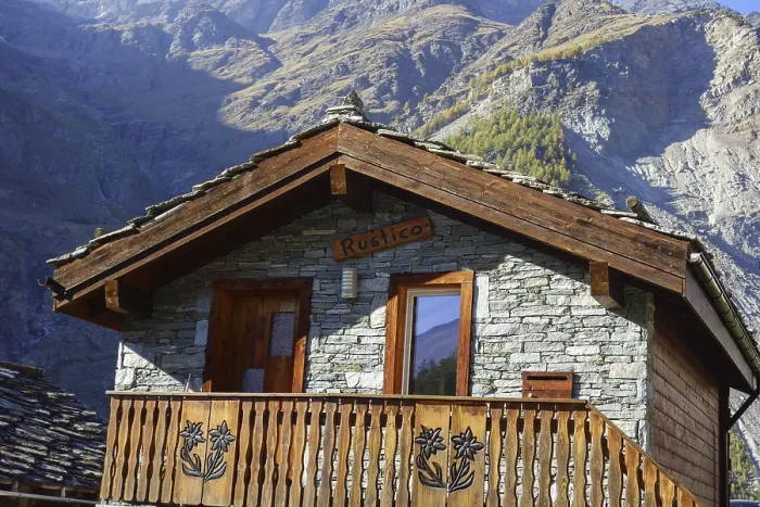 Framed Print : Rustic mountain hut with wooden balcony against an impressive mountain backdrop