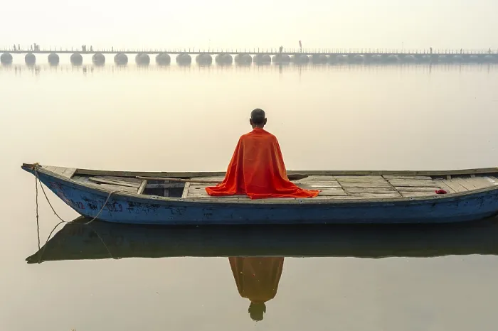 Framed Print : Sadhu with red shawl on a boat on the Ganges river at sunrise Framed Print : Sadhu with red shawl on a boat on the Ganges river at sunrise