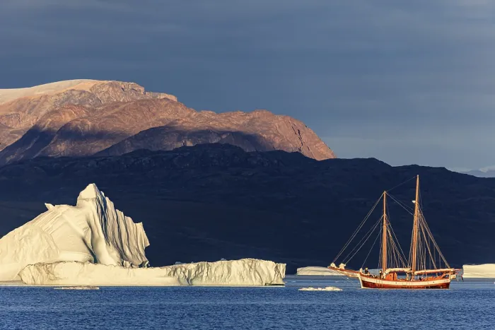 Framed Print : Sailing boat, ship in fjord in front of large icebergs and mountains Framed Print : Sailing boat, ship in fjord in front of large icebergs and mountains