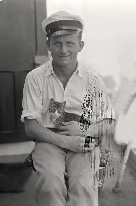Framed Print : Sailor with cat in his arms on board a cargo ship