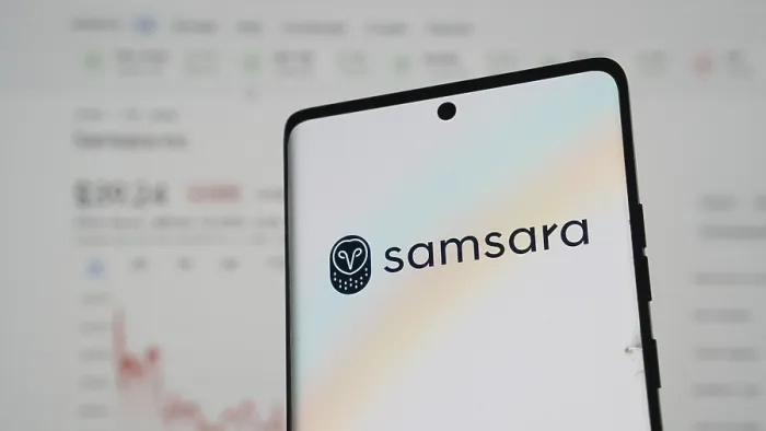 Framed Print : Samsara logo on a smartphone with pastel hues and financial chart in the background