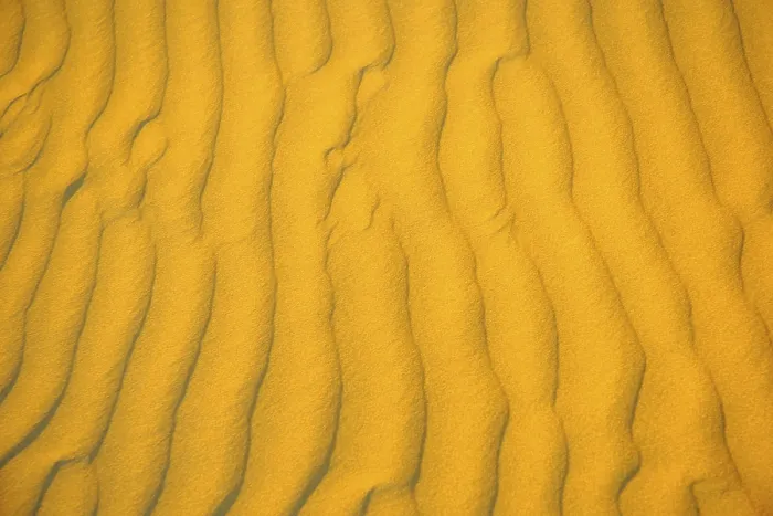 Framed Print : Sand pattern in form of ripples in morning light golden color Framed Print : Sand pattern in form of ripples in morning light golden color