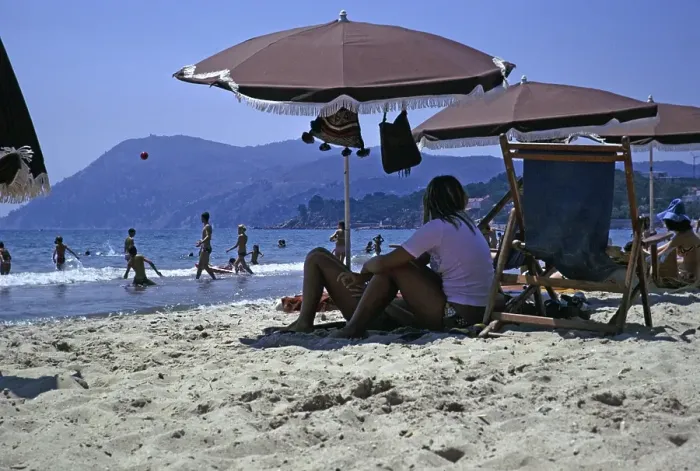 Framed Print : Sandy beach, children playing in the sea and people sitting under parasols, Les Sablettes, French Riviera, France 1974