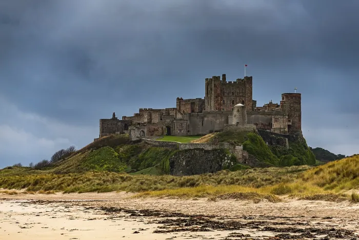 Framed Print : Sandy coast at low tide with Bamburgh Castle