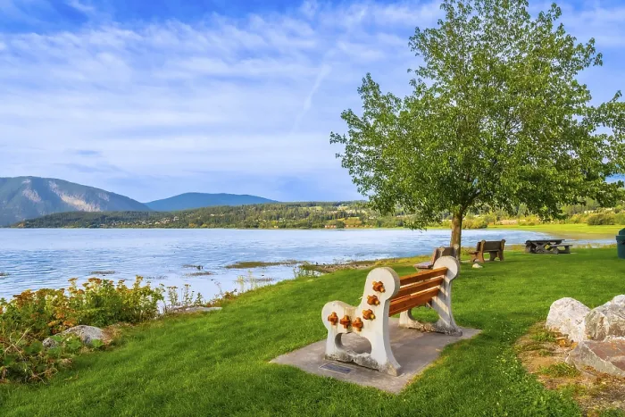 Framed Print : Scenic view of shuswap lake with a bench in the foreground
