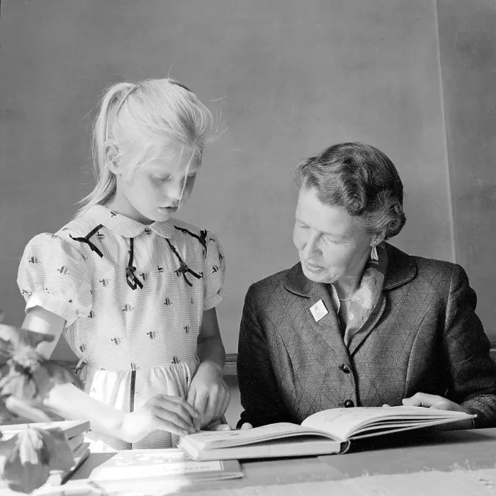 Framed Print : School in the 1950s. A girl with her teacher Framed Print : School in the 1950s. A girl with her teacher