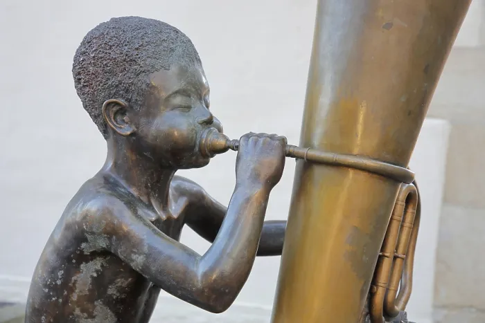 Framed Print : Sculpture boy with tuba by Guido Messer 1991