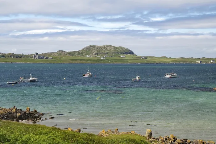 Framed Print : Sea view with several boats and a rocky coastline under a slightly cloudy sky Framed Print : Sea view with several boats and a rocky coastline under a slightly cloudy sky