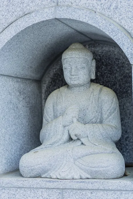 Framed Print : Seated Buddha in small alcove built inside concrete wall in Daejeon