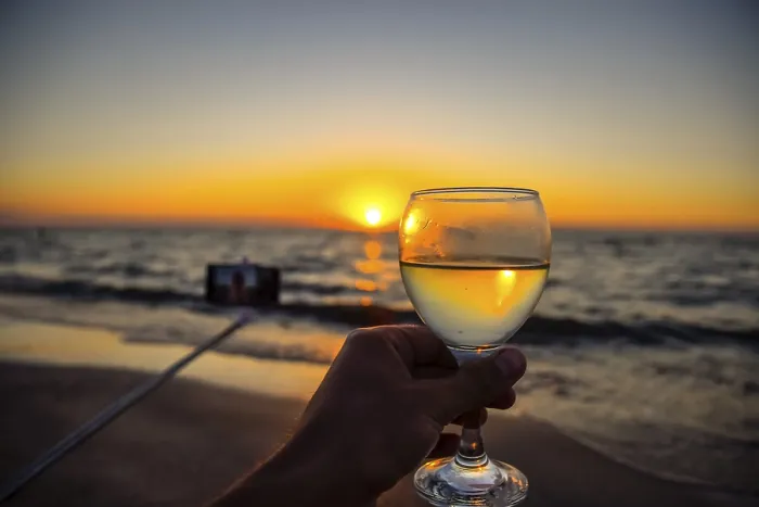 Framed Print : Selfie with a selfie stick on the beach at sunset with a glass of champagne