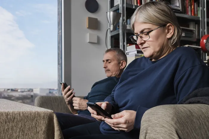Framed Print : A senior couple sits in their cozy living room Framed Print : A senior couple sits in their cozy living room